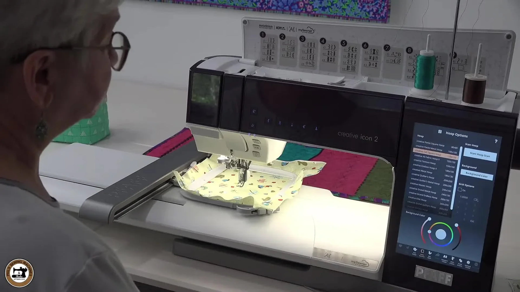 The Pfaff creative icon 2 is actively scanning a hooped fabric area while the hoop moves under the built-in camera for precise design placement.