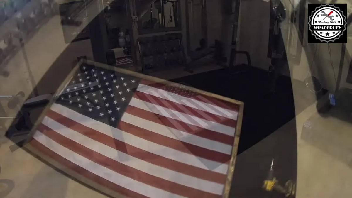 Four stained mitered strips arranged around an American flag