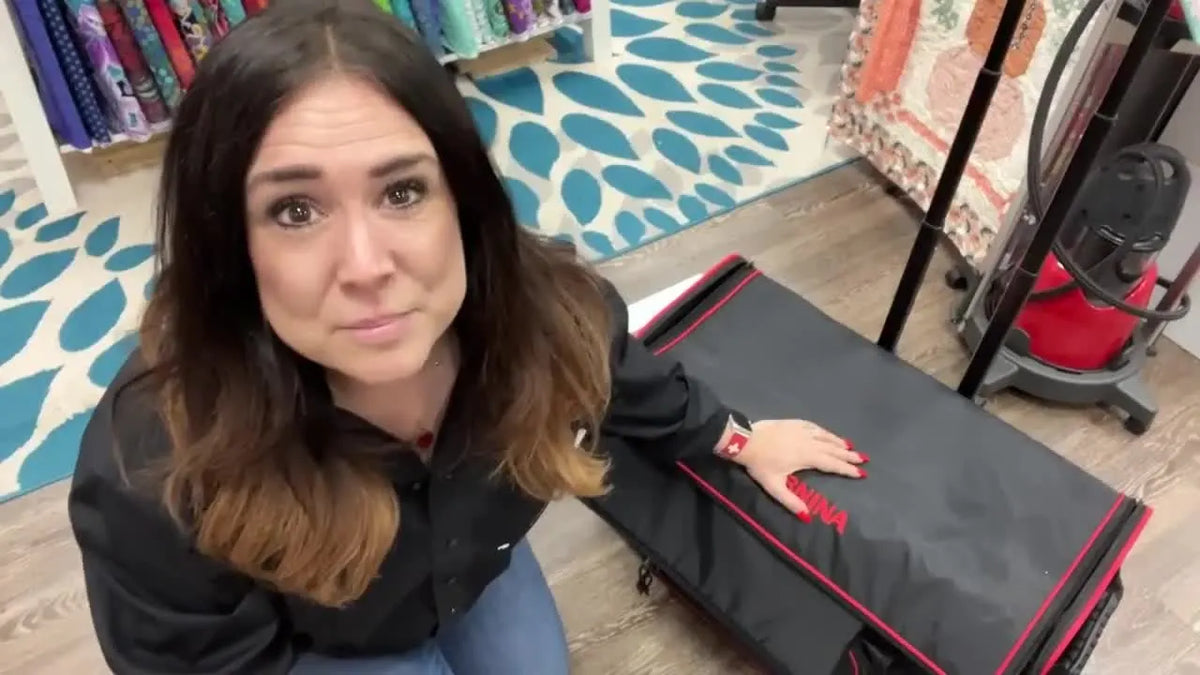 Woman introducing Bernina luggage system for 7 or 8 series machines.