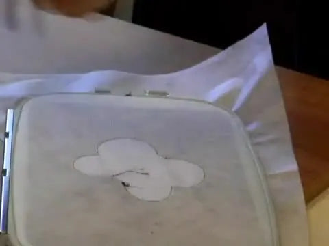 A completed dimensional embroidered topiary featuring layered freestanding flowers, a double-sided butterfly, and a decorated pot insert.