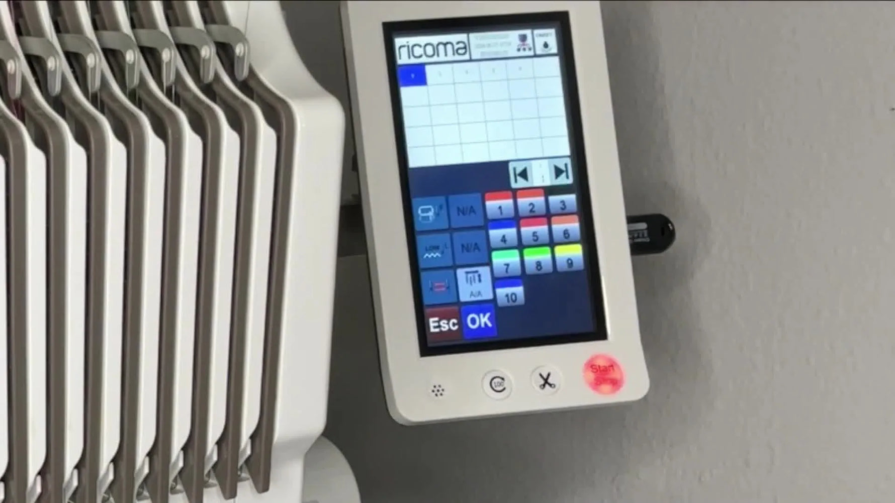 Side view of a structured cap mounted on a Ricoma EM-1010 during tracing, checking brim and needle-bar clearance before stitching.