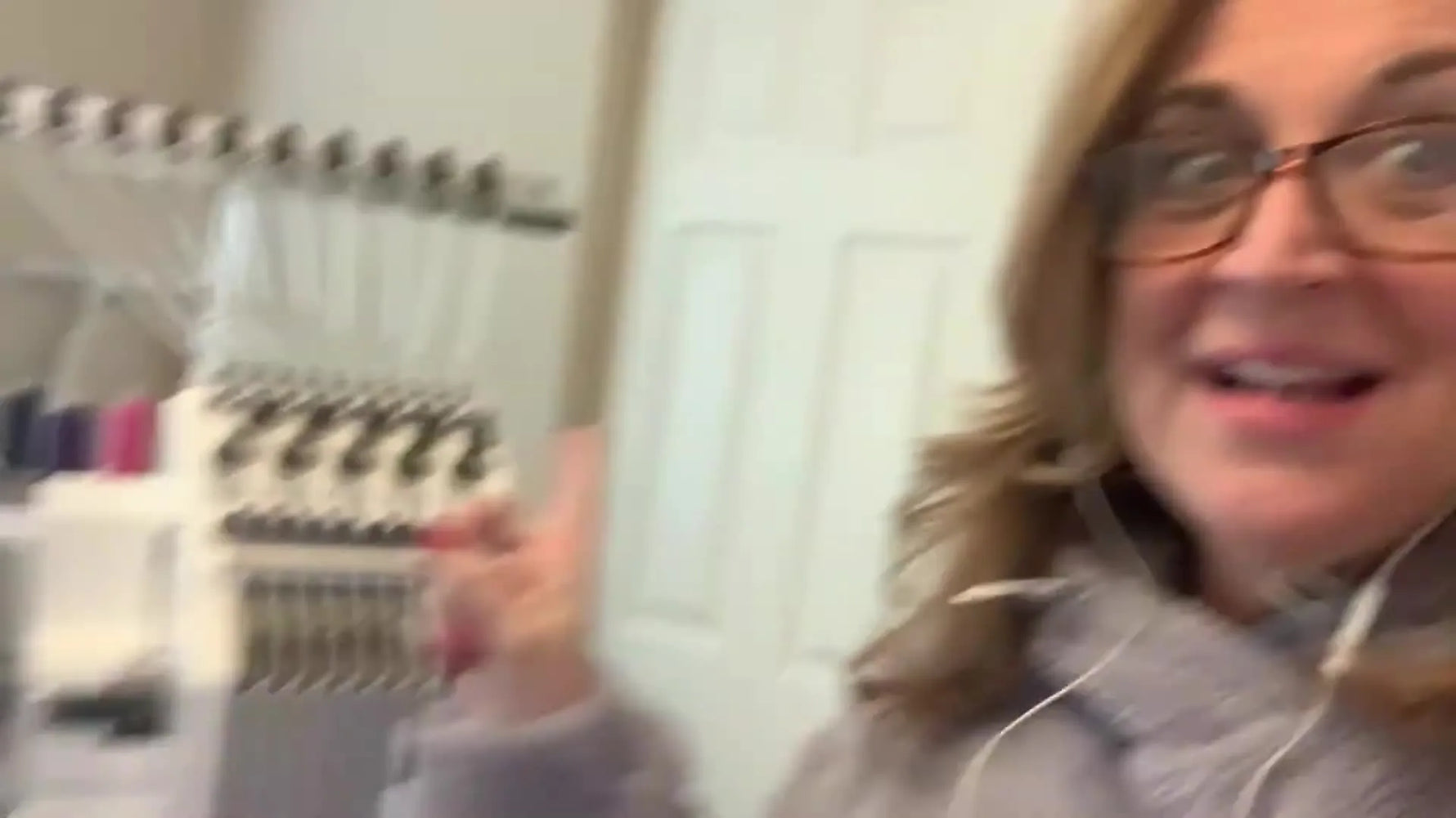 A new Ricoma EM-1010 owner stands beside the freshly unboxed multi-needle machine, ready to set it up correctly the first time.