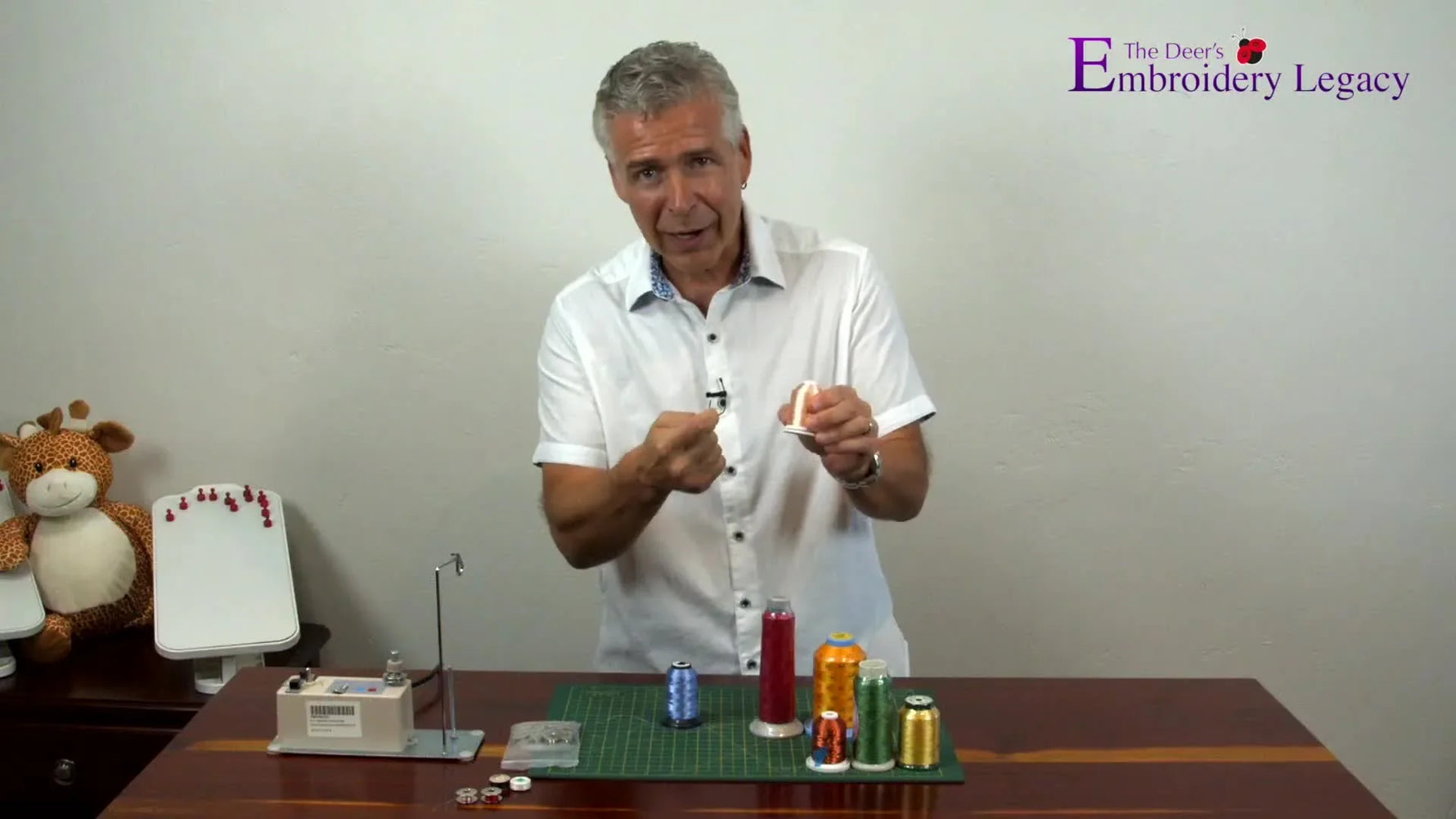 A close view of a demonstrator snapping rayon thread by hand to show how easily it breaks compared with polyester.