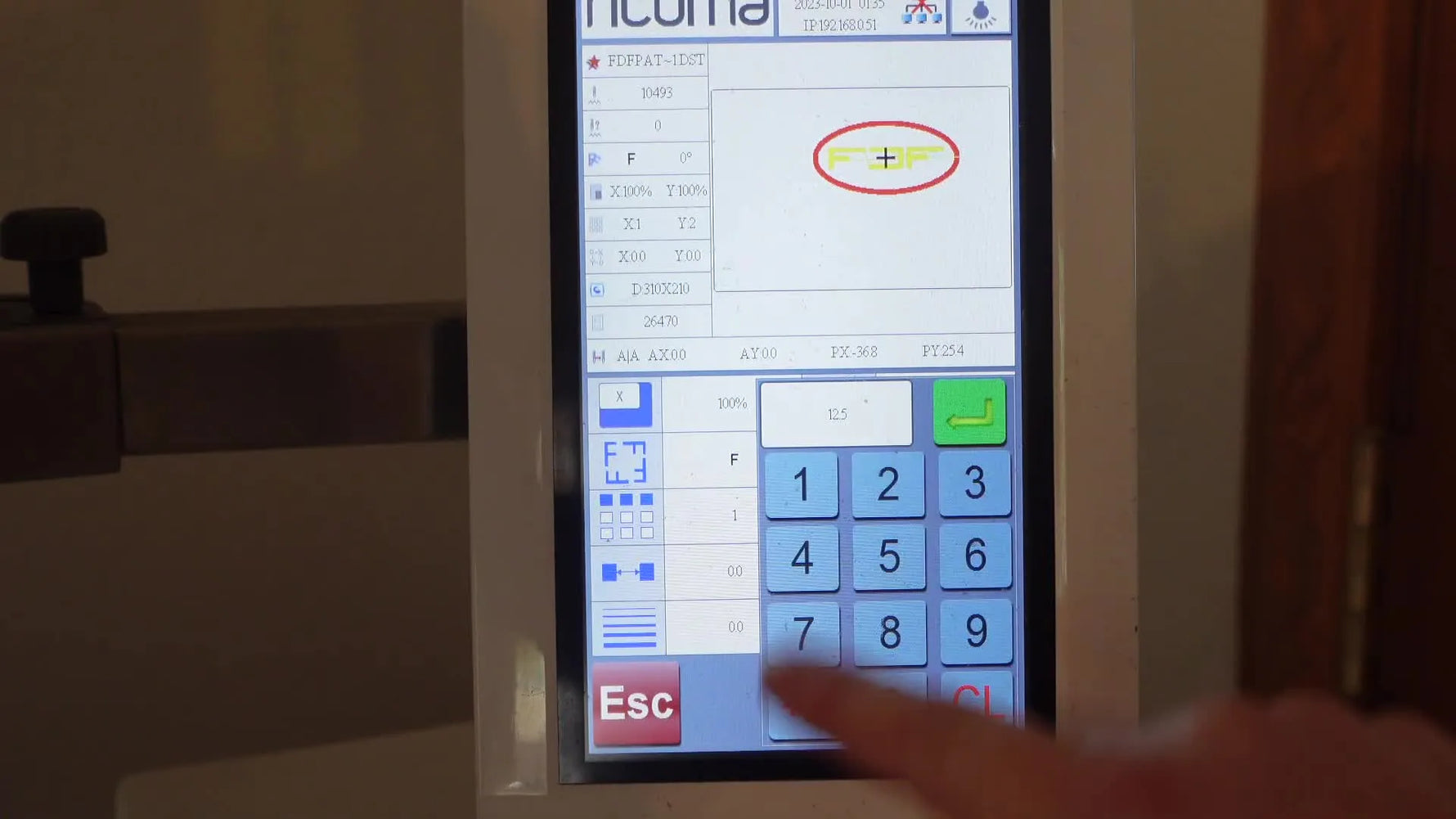 The Ricoma EM-1010 screen demonstrates the spacing input trick—typing 1250 to display 125.0—so duplicated patch designs separate correctly.