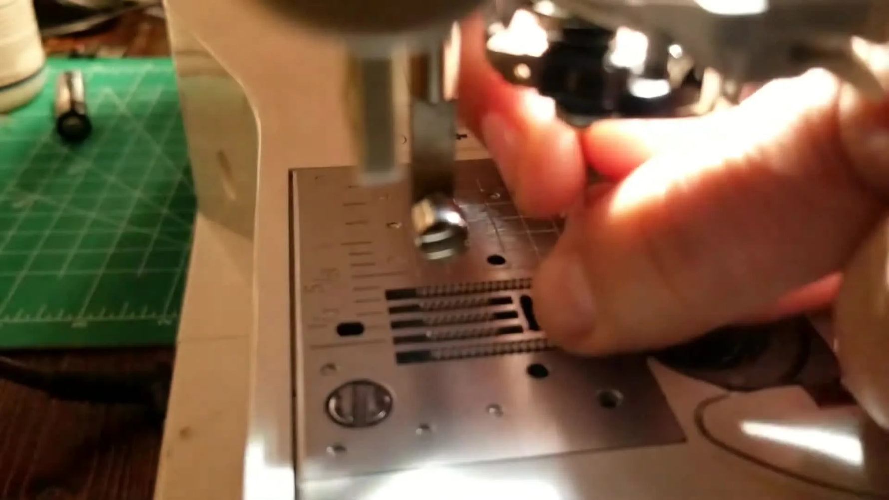 Automatic needle threader engaging with the needle.