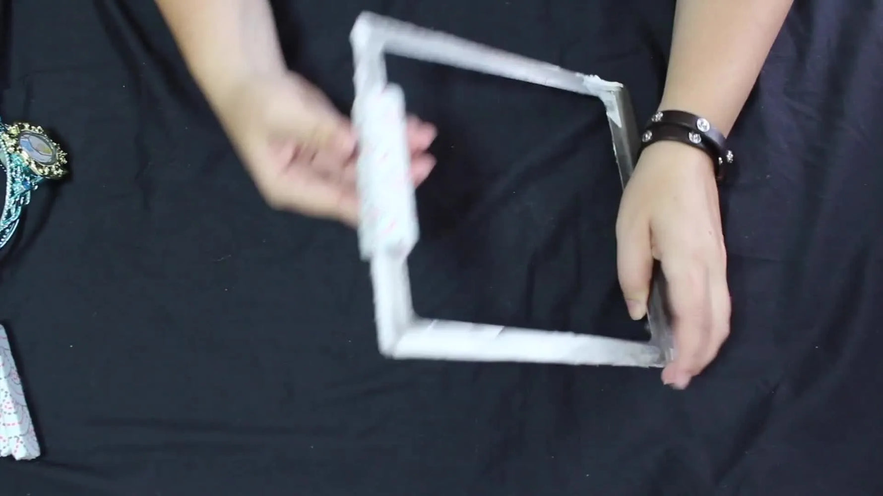 A wrapped magnet snaps onto the side of a metal Fast Frame, clamping the fabric and stabilizer tightly in place.