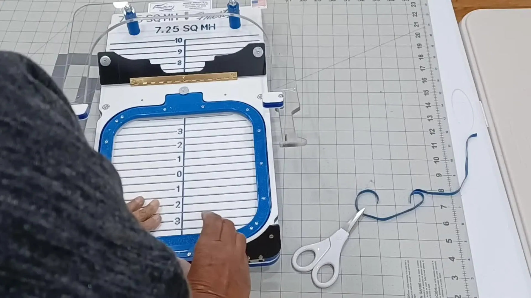 Hands demonstrate the moment a 7.25-inch magnetic Mighty Hoop snaps onto the bottom ring on a HoopMaster Station.