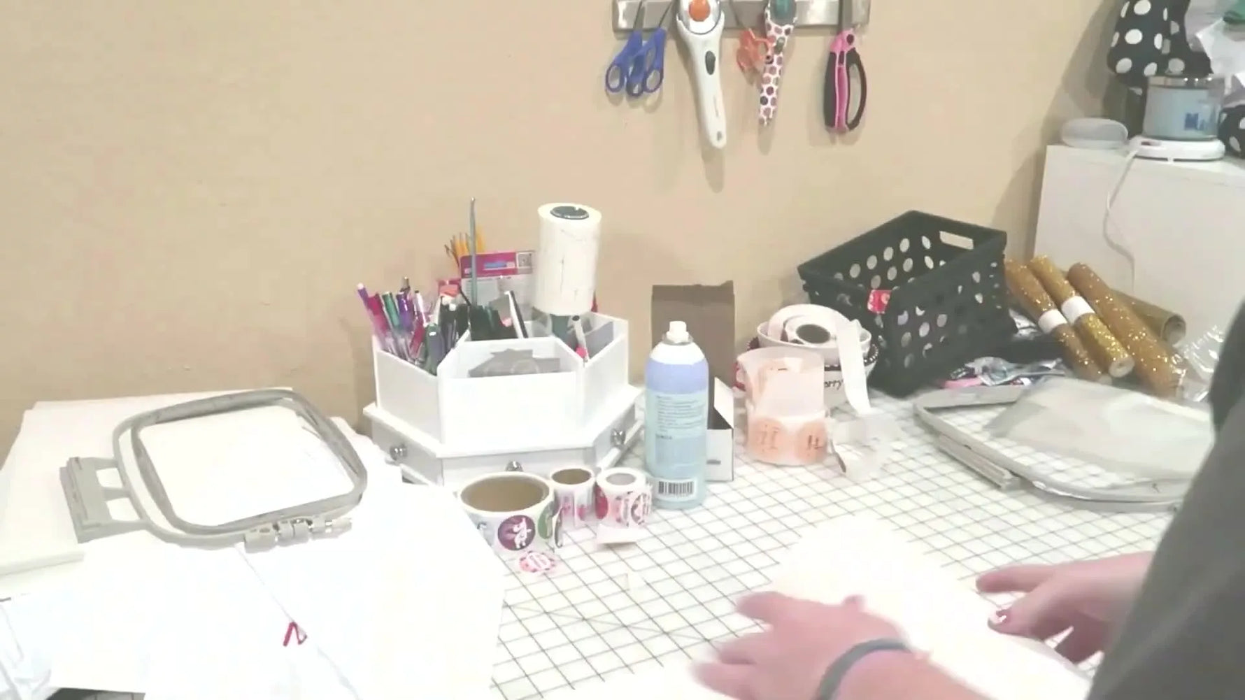 Woman preparing to hoop a white garment for embroidery.