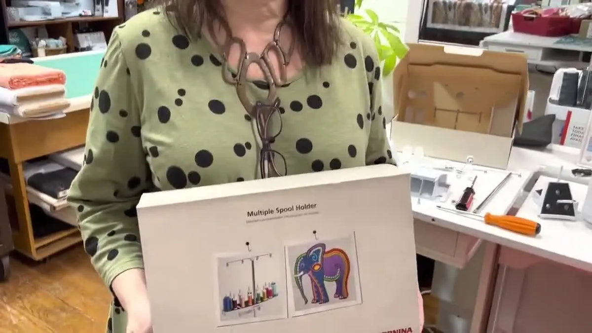 Woman holding the Bernina Multiple Spool Holder box