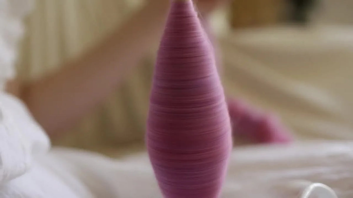 Woman demonstrating continuous spinning with a purple cop.
