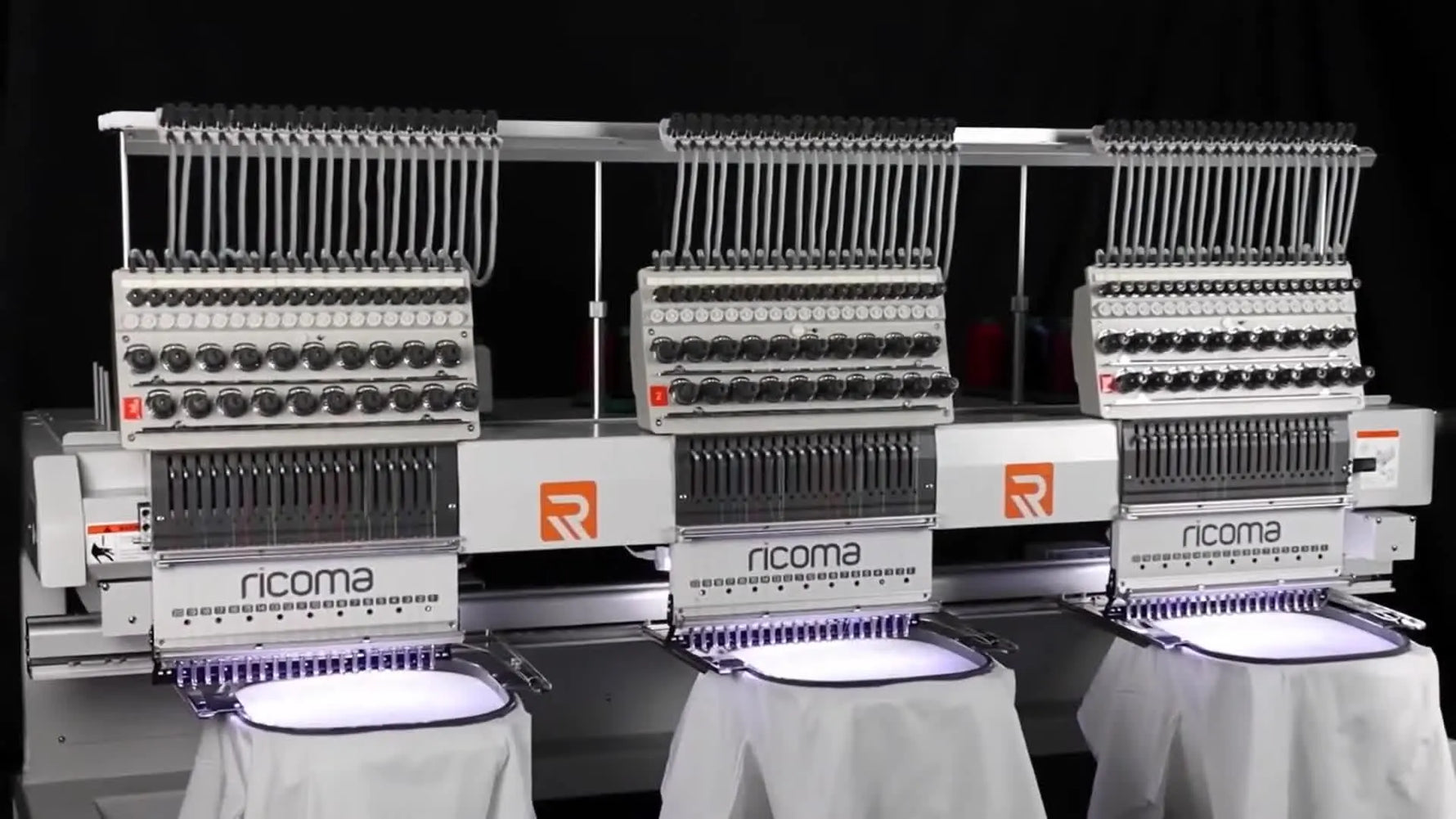 A close-up of a Ricoma machine actively stitching a floral design, highlighting the needle bar area where speed and tension choices show up in real production.