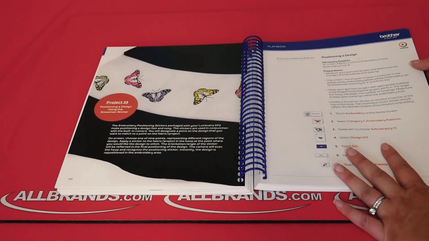 An overhead view of the Playbook page demonstrating Snowman Sticker positioning to correct crooked hooping on the Brother Luminaire XP2.