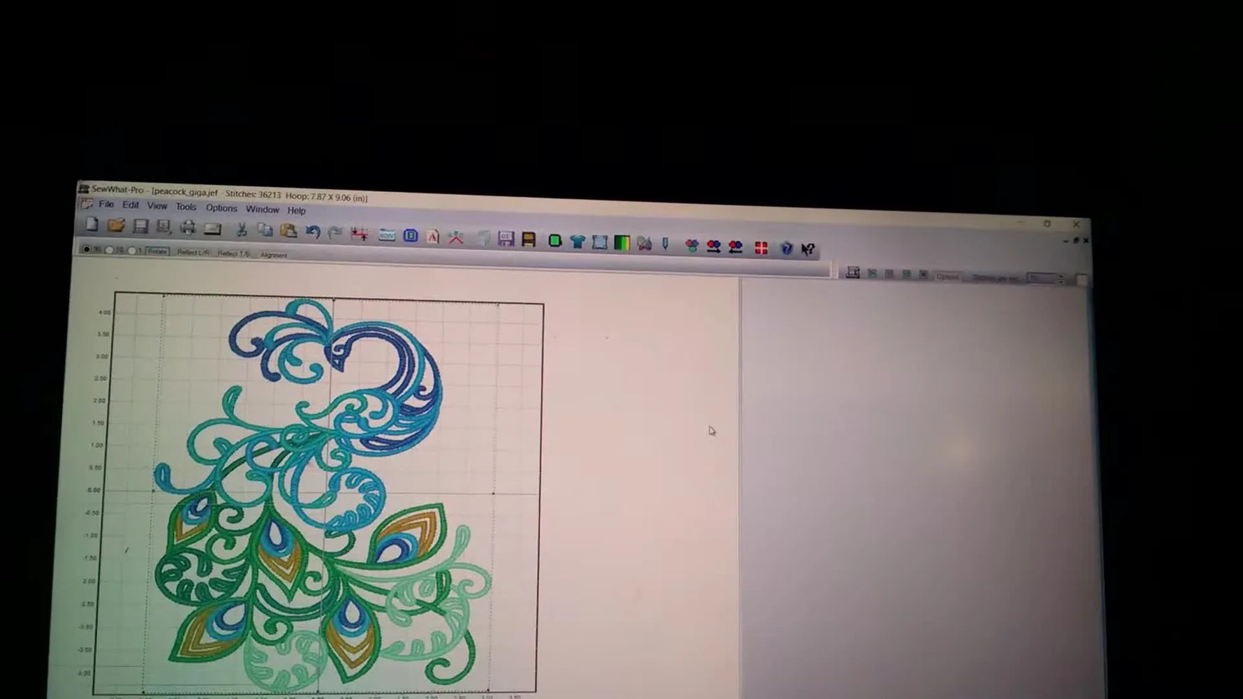 A resized peacock design fills the Janome Giga Hoop grid in SewWhat‑Pro, showing how close you can push the boundaries before splitting.