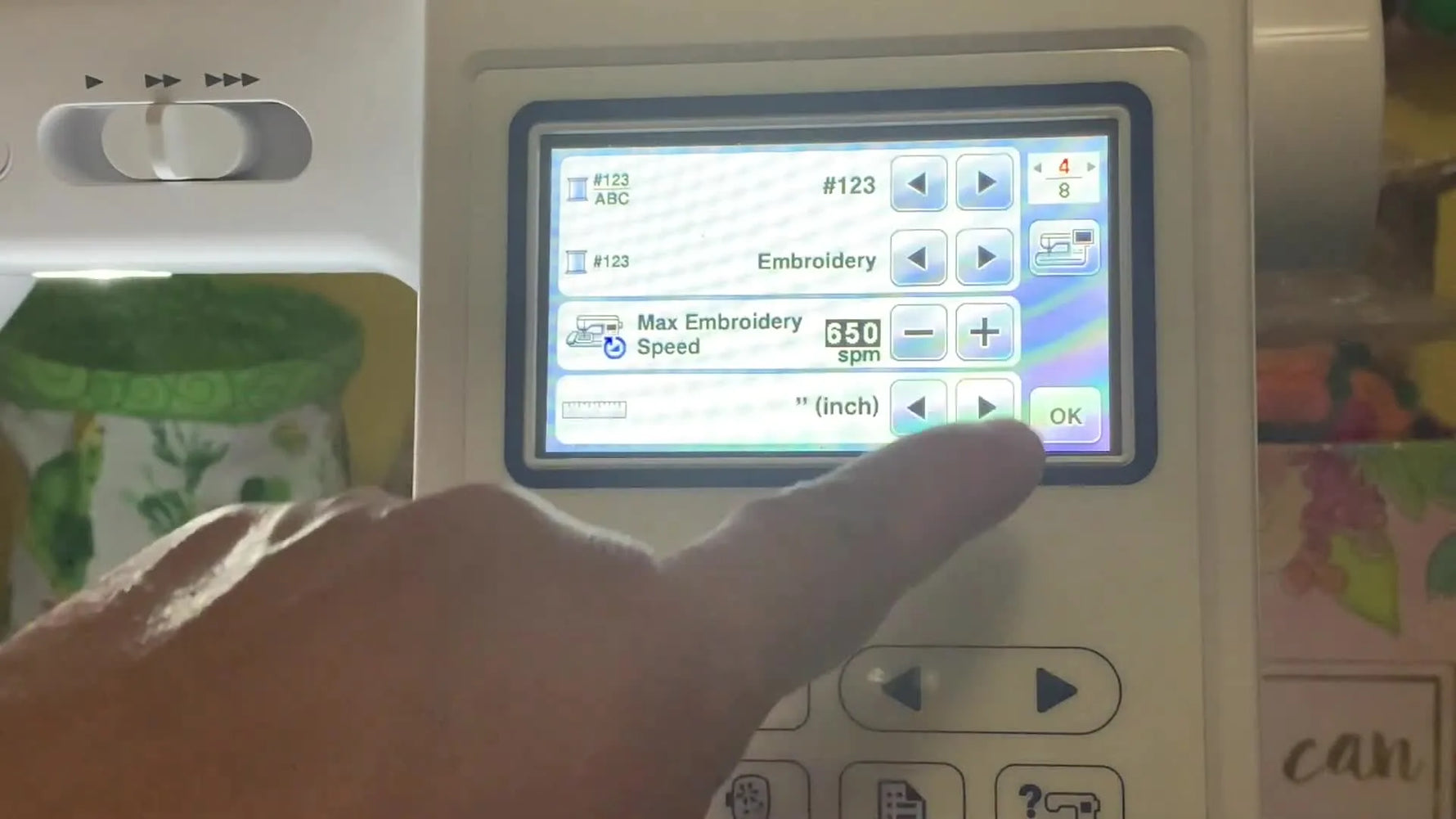 Close-up of a Brother embroidery machine settings screen where the measurement unit changes from mm to inches.