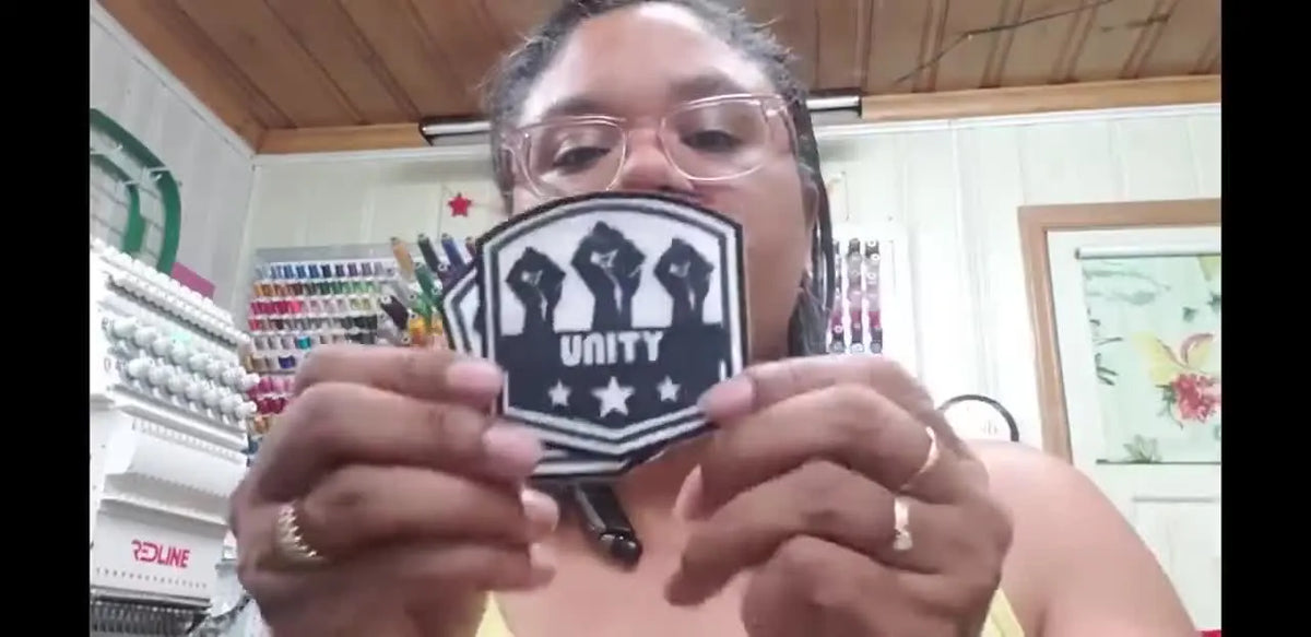 Woman holding sublimated UNITY patches