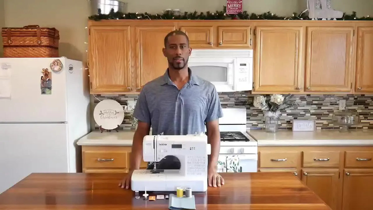 Man presenting sewing machine and supplies