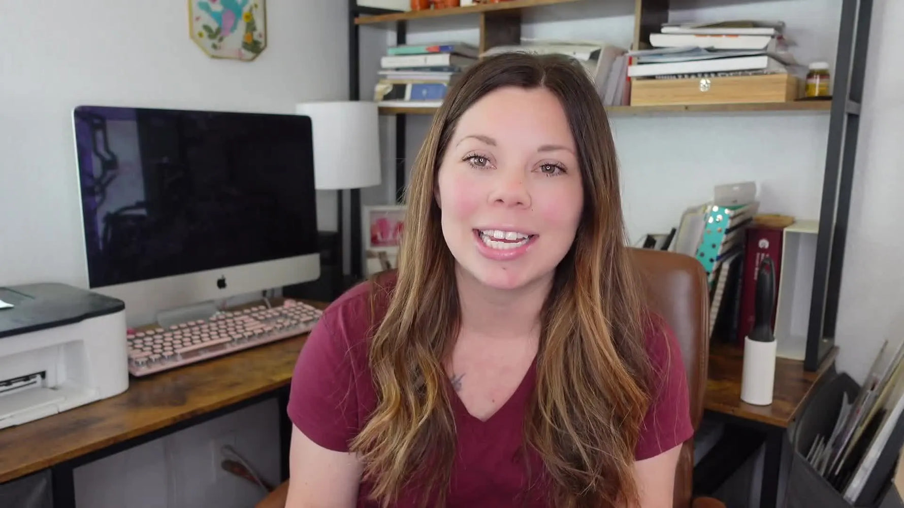 Woman holding up a blue and white trucker hat with a brown leatherette patch that says 'DAD' in cut-out letters, revealing a pink floral fabric underneath.