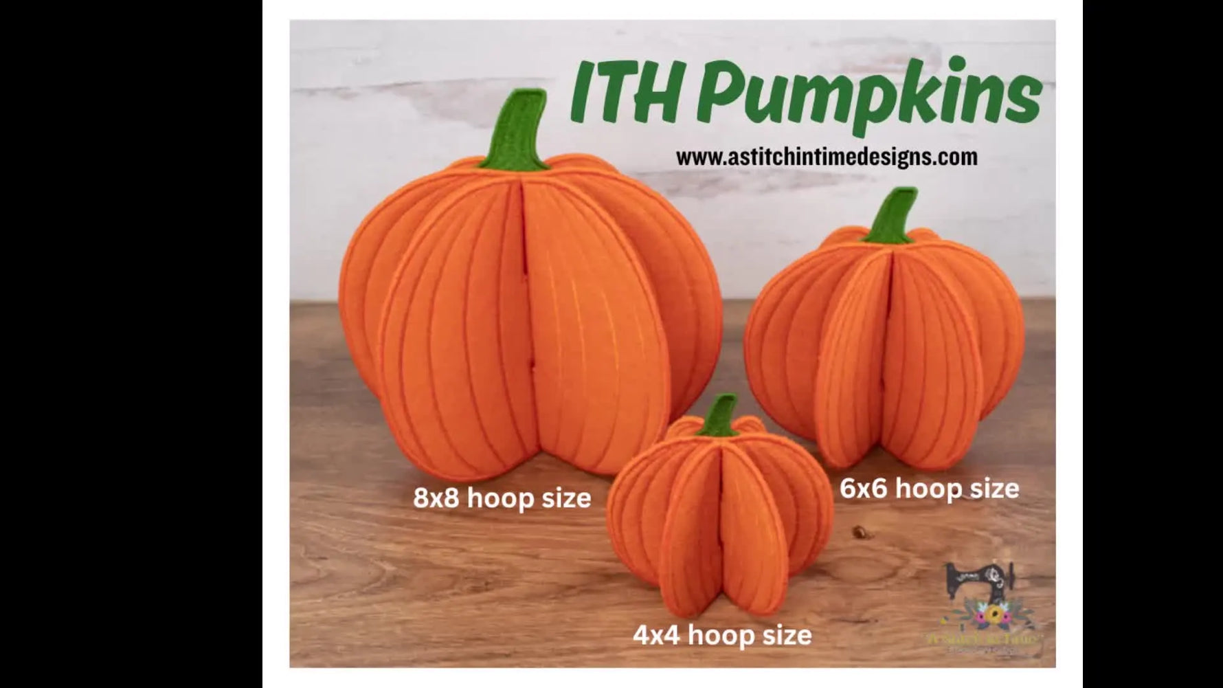 Three finished orange in-the-hoop felt pumpkins in different sizes stand upright on a wooden surface.