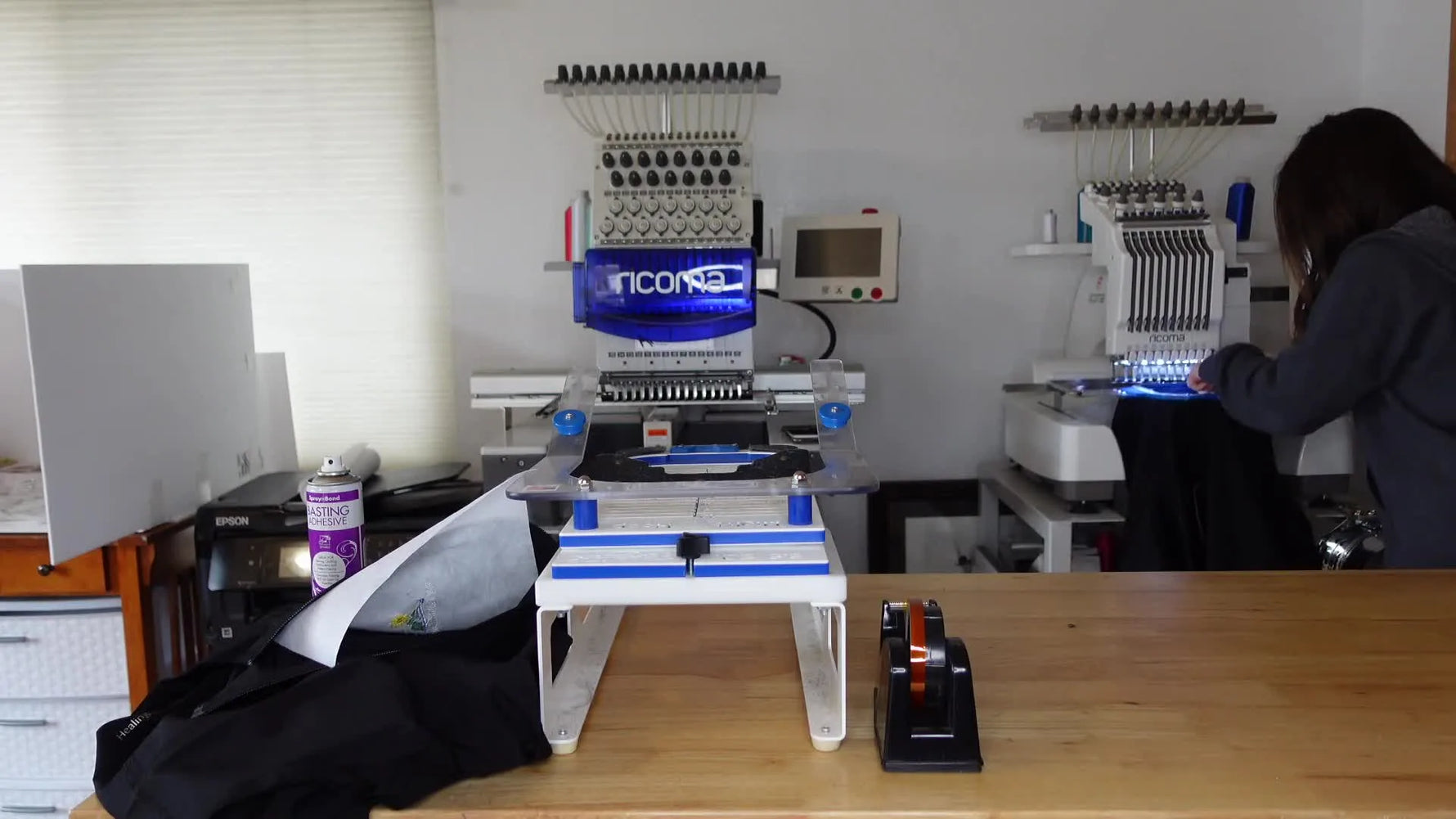 Clean, finished left-chest embroidery on a black scrub jacket.