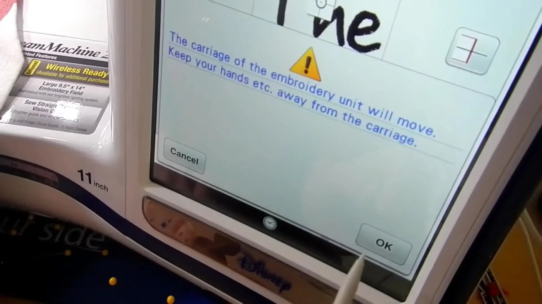 The Brother Dream Machine 2 screen shows the camera recognizing the Snowman positioning sticker and auto-aligning the embroidery design.
