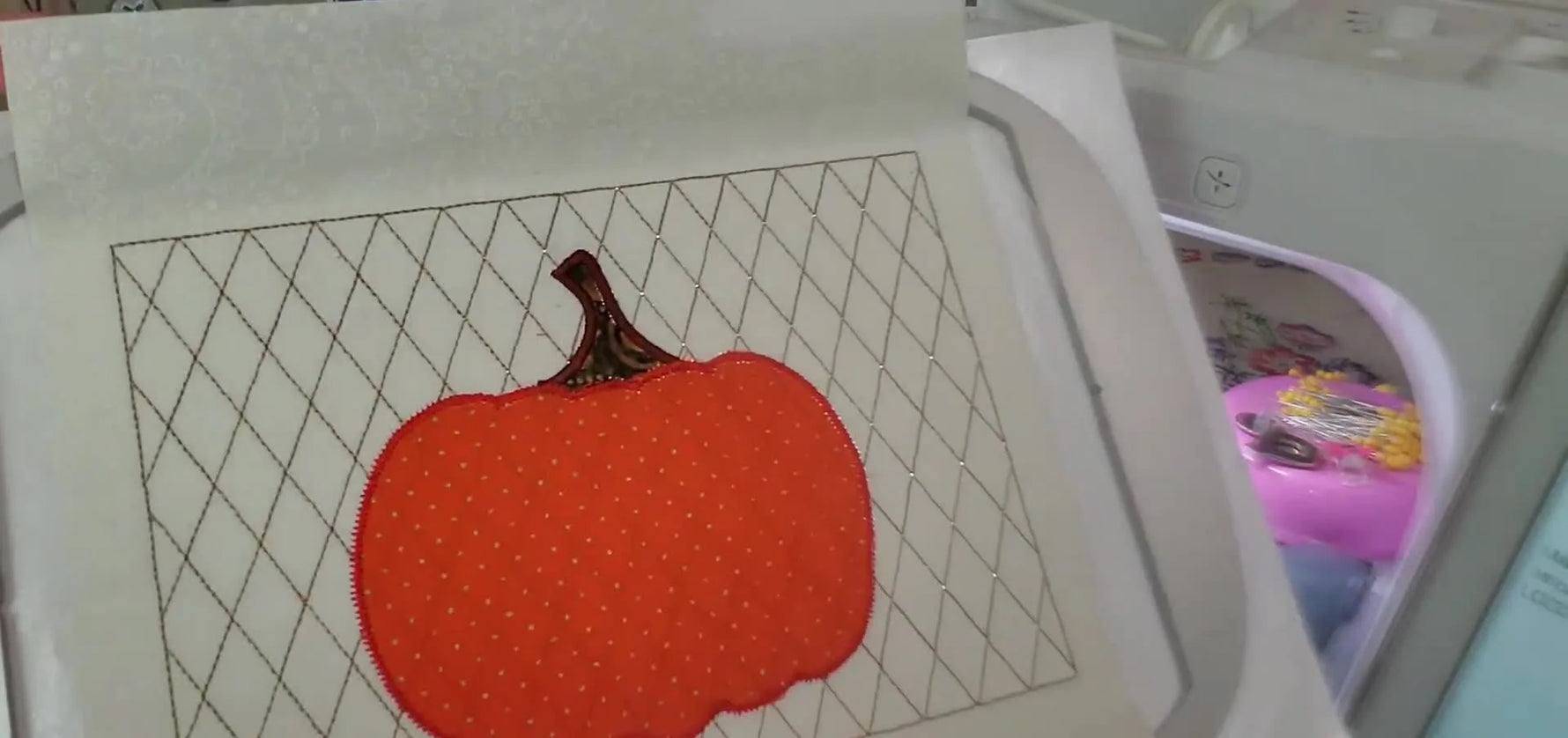 A finished pumpkin appliqué block with a decorative gold scalloped fill and crisp satin outlines, ready to become a mug rug, towel panel, or quilt block.