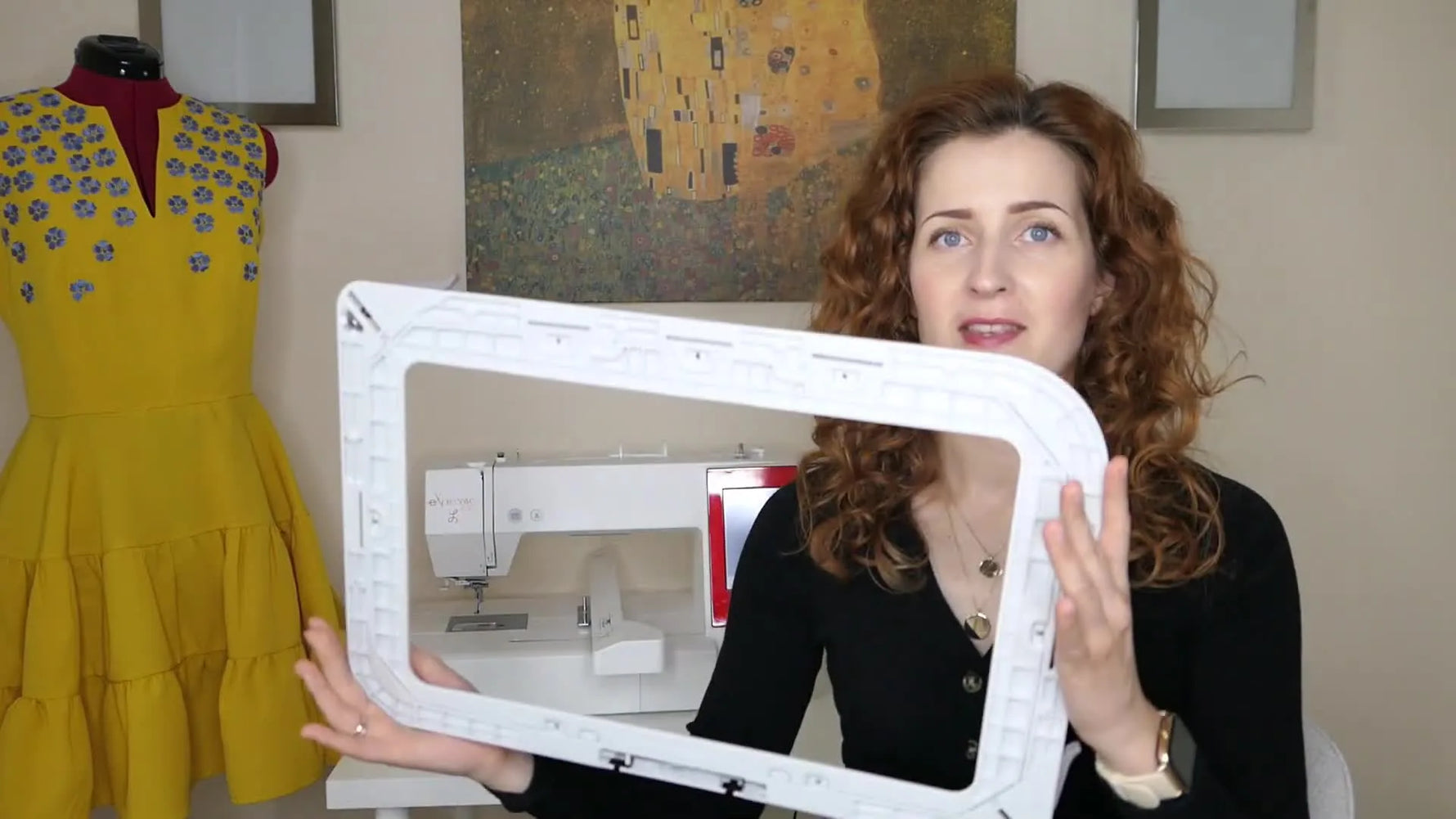 The creator holds the oversized RE36b hoop beside her face to show how much garment coverage the 200×360mm frame can handle.