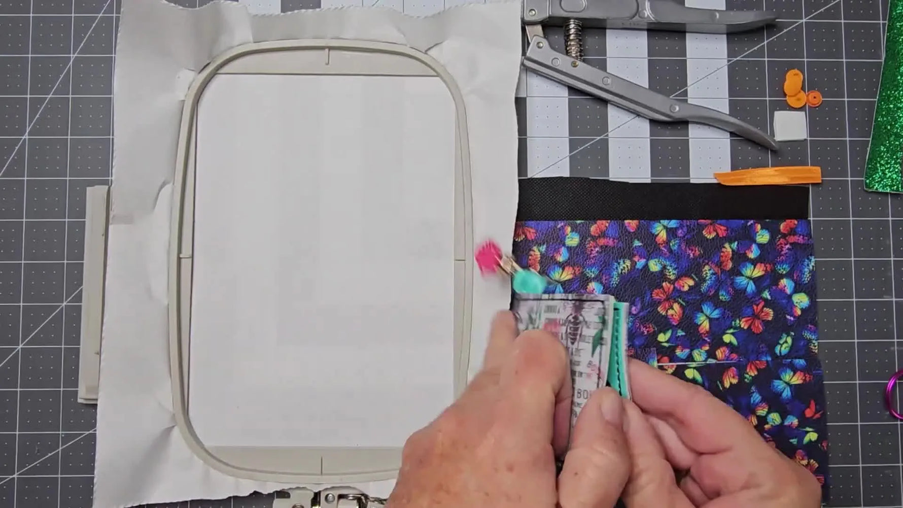 A close-up of the finished Bend Wallet being flexed to show how the vinyl folds cleanly while still holding cards securely.