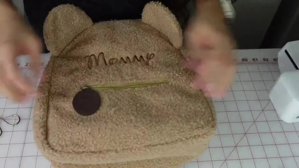 Finished teddy bear backpack embroidered with 'Mommy'.