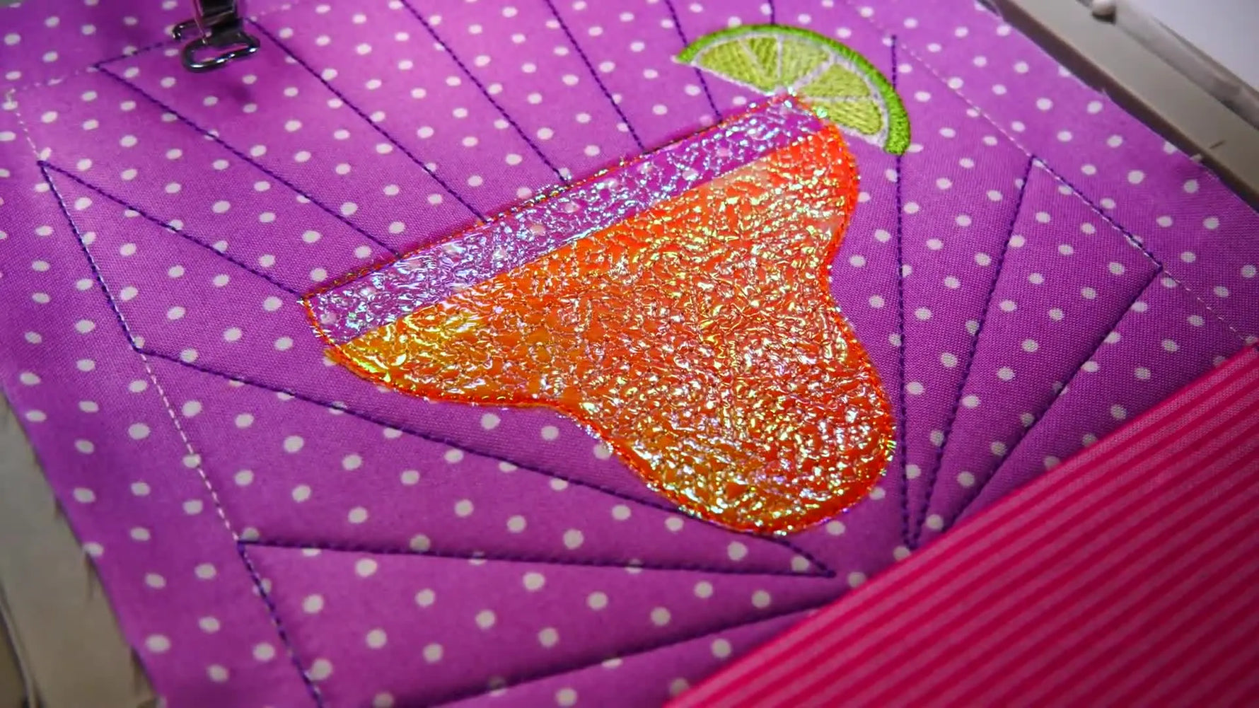 A close-up of the finished cocktail-glass shimmer effect after stippling stitches flatten the Mylar and create a faux glass look.