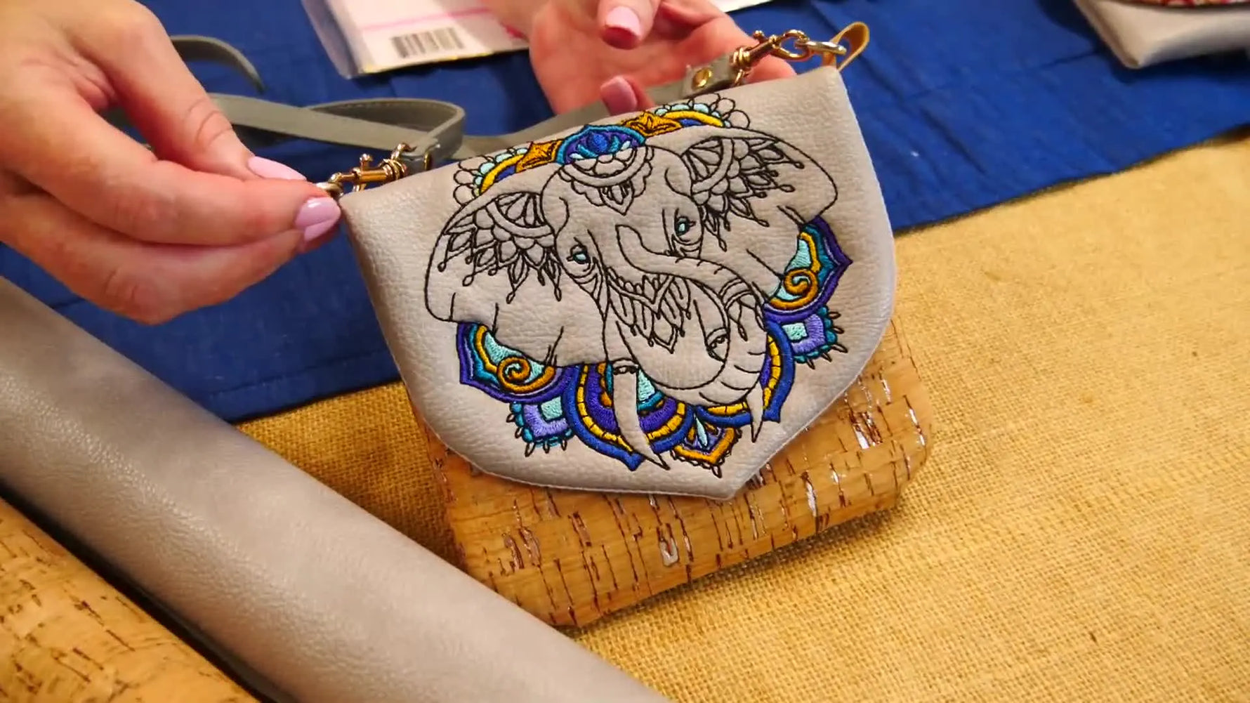 Close-up of the finished ITH Elephant Zipper Purse showing the redwork-style elephant embroidery on the flap with cork visible behind it.