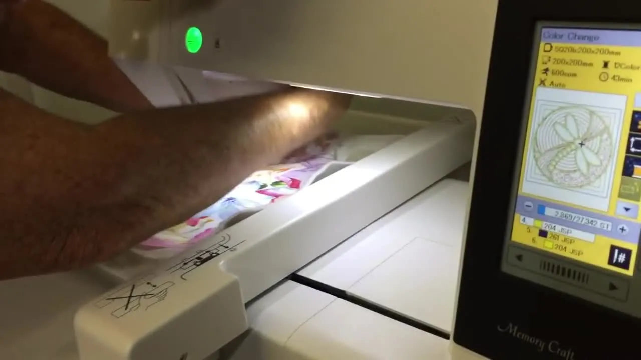 Close-up of the Janome embroidery machine screen displaying 'Color Change' and 'stitch number 4' for the current embroidery step.