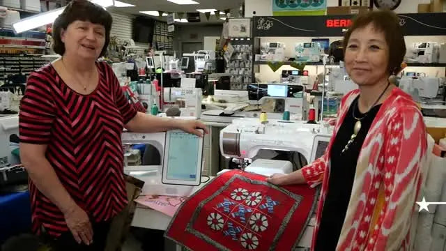 A close-up shows a finger tracing the raised texture of couched yarn stitches on the Deer embroidery sample.