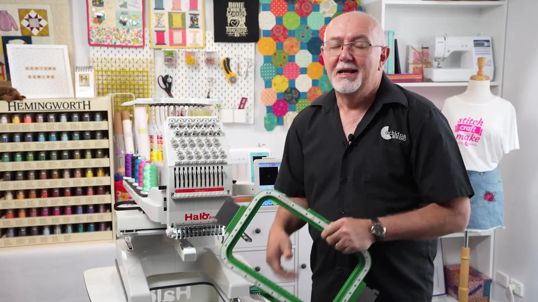 Gary holds the large green MaggieFrame 320×200 magnetic hoop in front of the Halo-100 12-needle embroidery machine to show the upgrade you’re about to install.