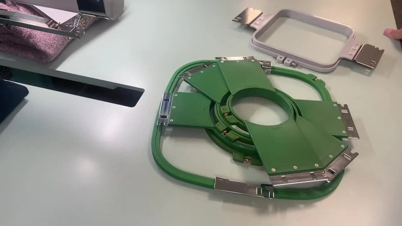 Table with various green embroidery hoops laid out.