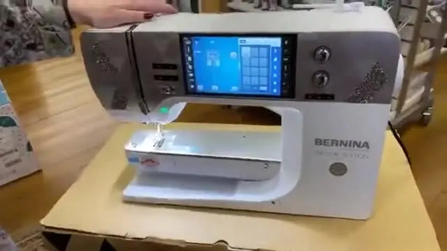 A close-up of the Bernina 590 Crystal Edition with a silver faceplate covered in Swarovski crystals, shown as the premium upgrade option discussed in the live session.
