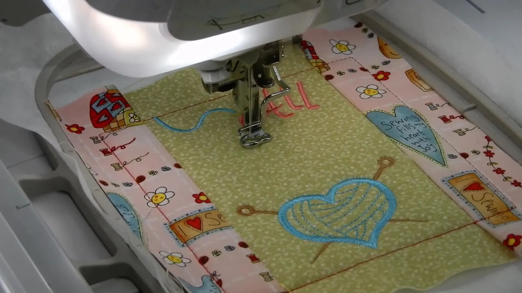 An overhead view of the finished knitting-themed embroidery design completed in the hoop before trimming.