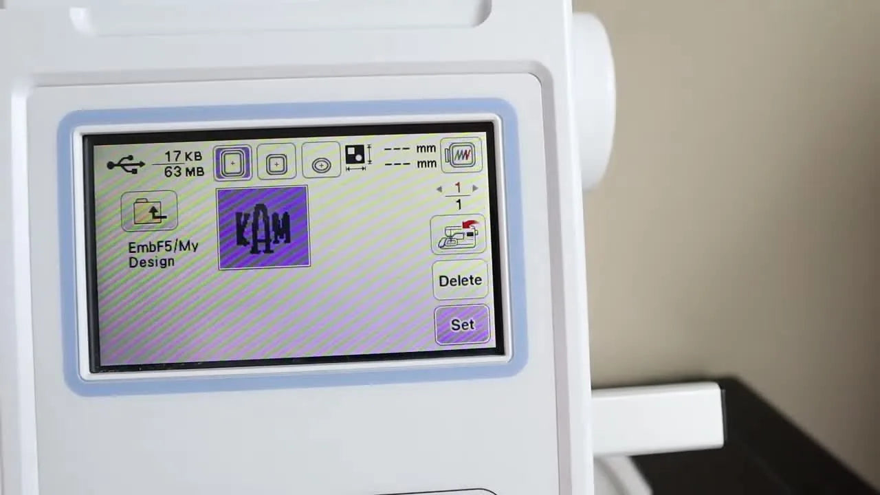 A close view of the Brother PE800 control area as the green Start button is pressed to begin stitching.