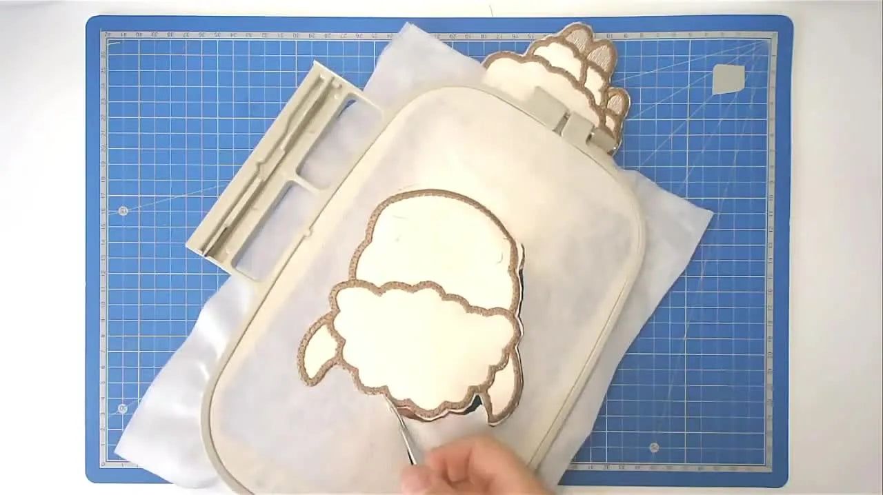 The finished large llama appliqué is displayed flat on a table, showing the clean edges and the optional heart detail.