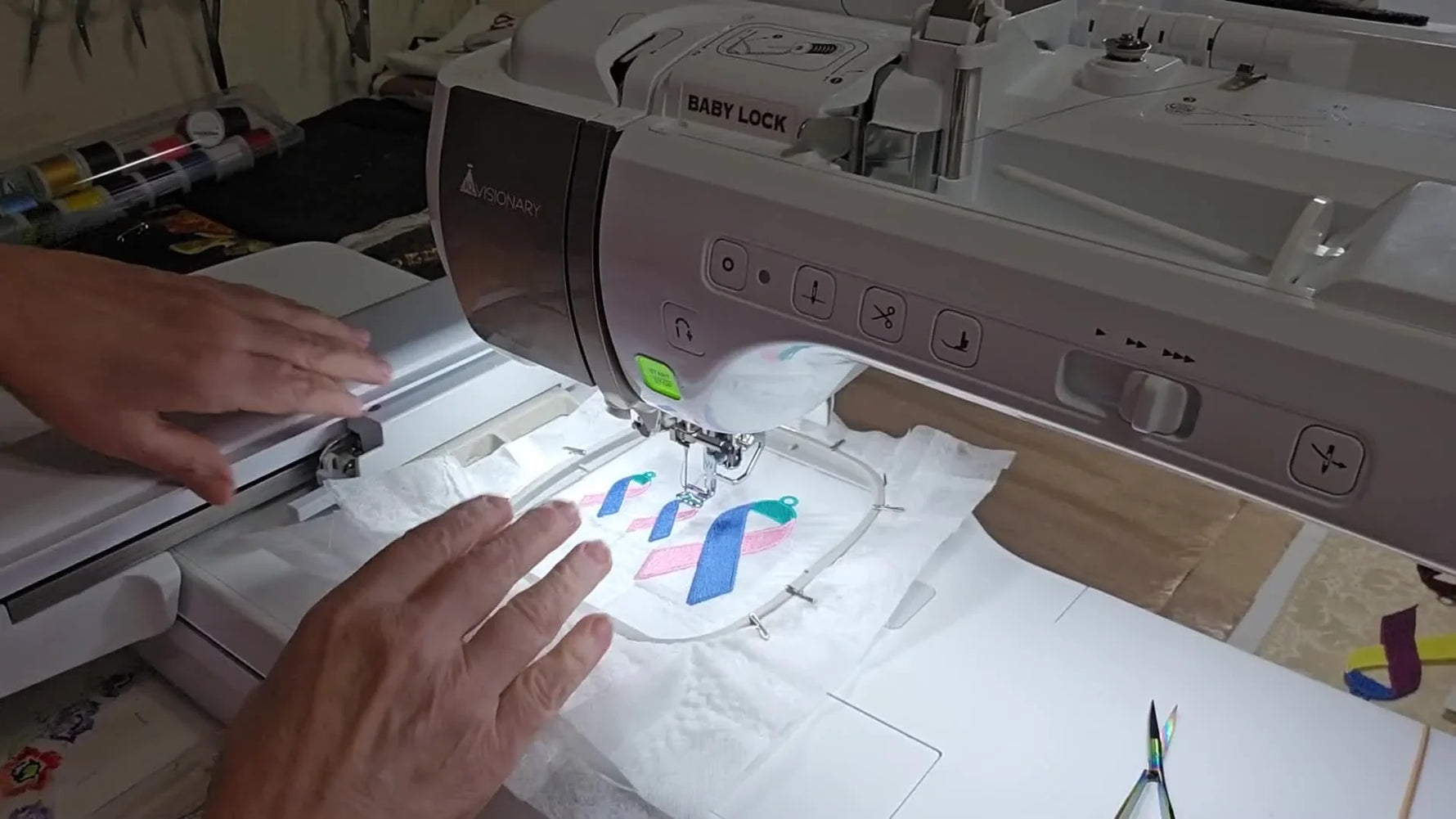The finished multi-piece Thyroid Cancer Awareness Ribbon set is fully stitched in the hoop on white wash-away stabilizer, ready for trimming and removal.