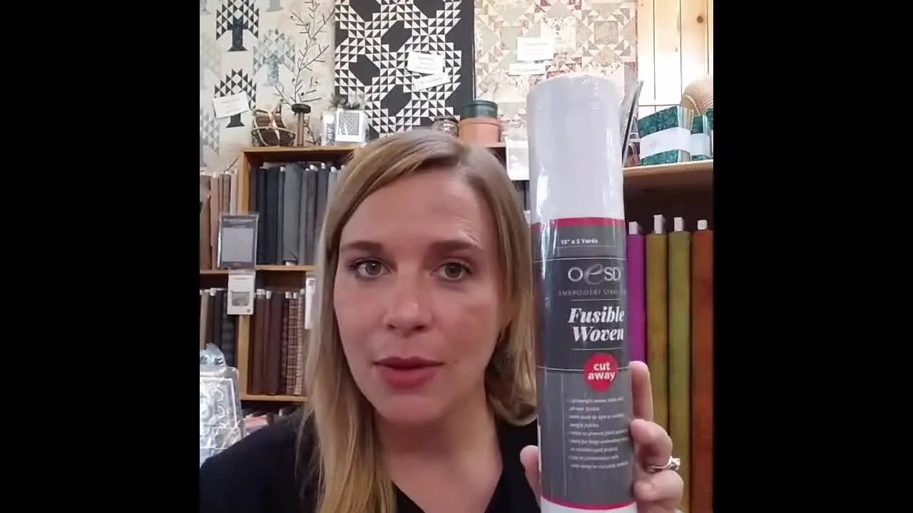 A close-up of the OESD Fusible Woven stabilizer roll, highlighting the roll storage that helps prevent deep wrinkles before fusing.
