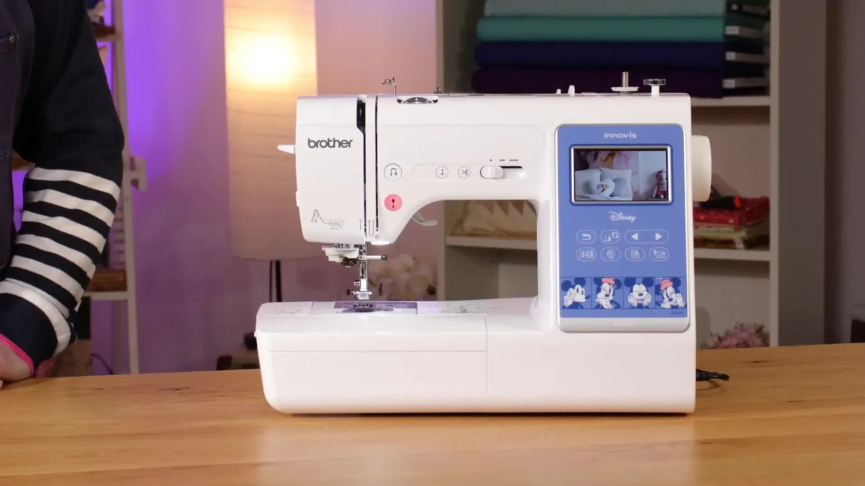 A wide shot of the Brother M380D sewing and embroidery machine set up on a table, ready to demonstrate both sewing and embroidery modes.