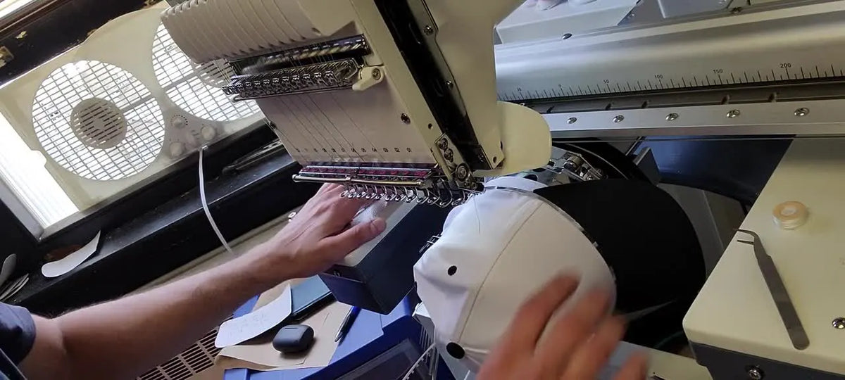 Hands placing a cap in the hat driver