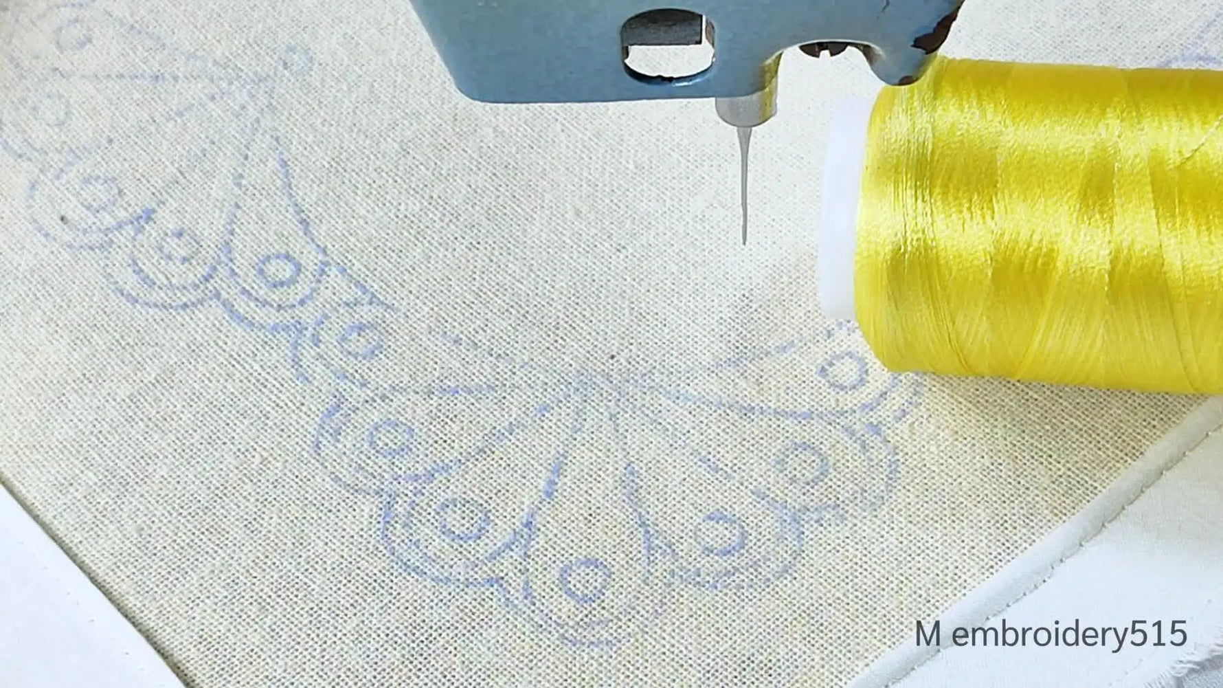 An overhead view of an embroidery machine needle poised over light fabric, next to a spool of bright yellow thread. Text overlays indicate 'Cut work' and 'Machine embroidery'.