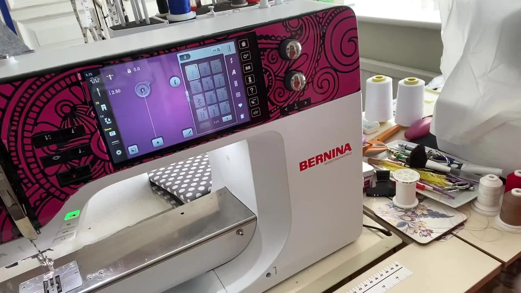 A Bernina 790 Plus sits powered on with its illuminated touchscreen, ready to run a firmware update from the settings menu.
