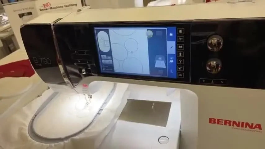 A close-up of a stylus moving the on-screen crosshair for pinpoint placement on a Bernina embroidery screen.