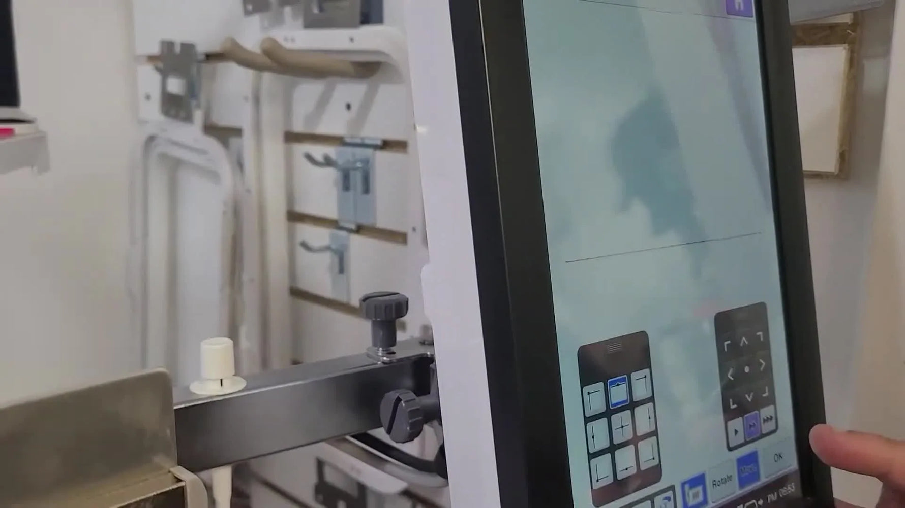 The Brother PR1050X screen shows a live camera view of the needle position relative to the magnetic hoop’s inner edge for a final clearance check.