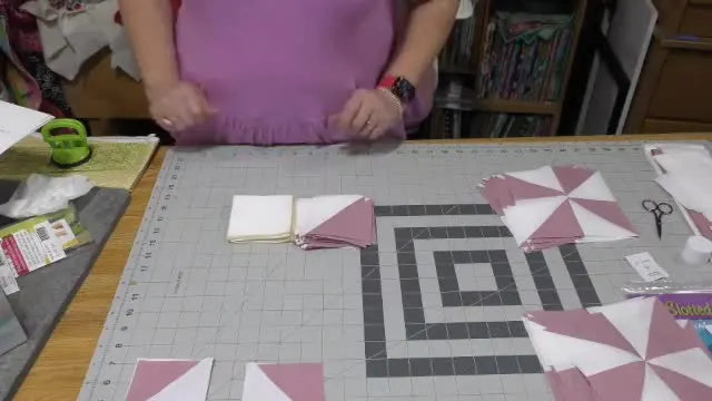 The full Dancing Pinwheels quilt layout is shown on a design wall so you can verify block orientation and row order before sewing everything together.