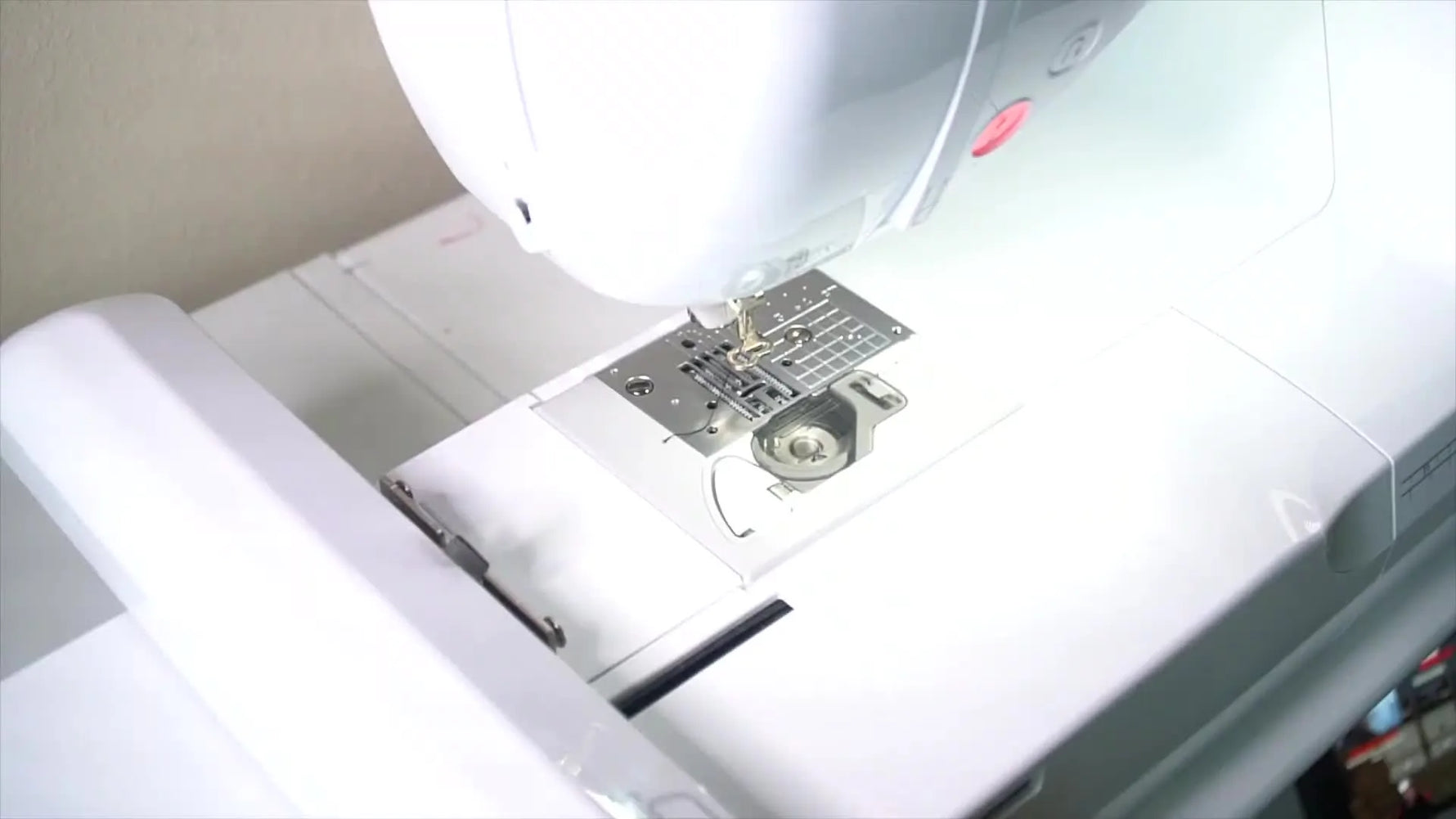 A fully completed Mardi Gras mask embroidery design in a 4x4 hoop, showing crisp satin fills and a clean black outline.