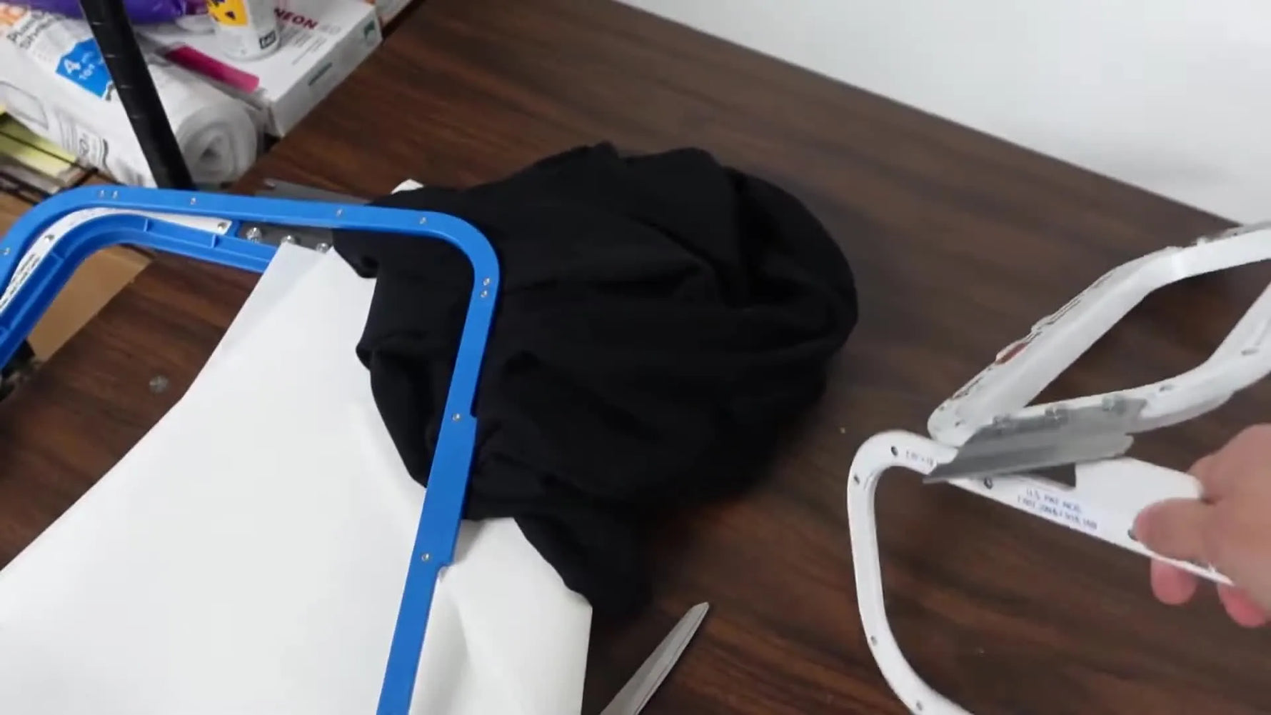 A close-up of the long, narrow 13×4.25 magnetic hoop being held up to show why it fits wide chest text without wasting stabilizer.