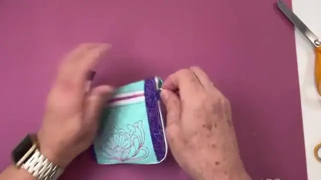 The finished Fold Away Tote is shown folded neatly into its integrated zippered pouch, demonstrating the final compact result.